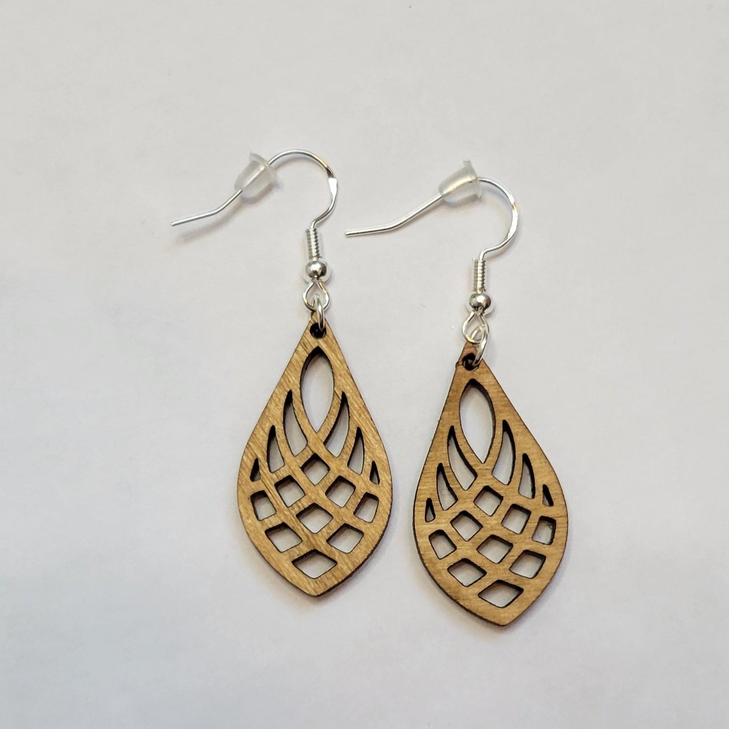 golden oak wooden laser cut teardrop patterned earring on white background