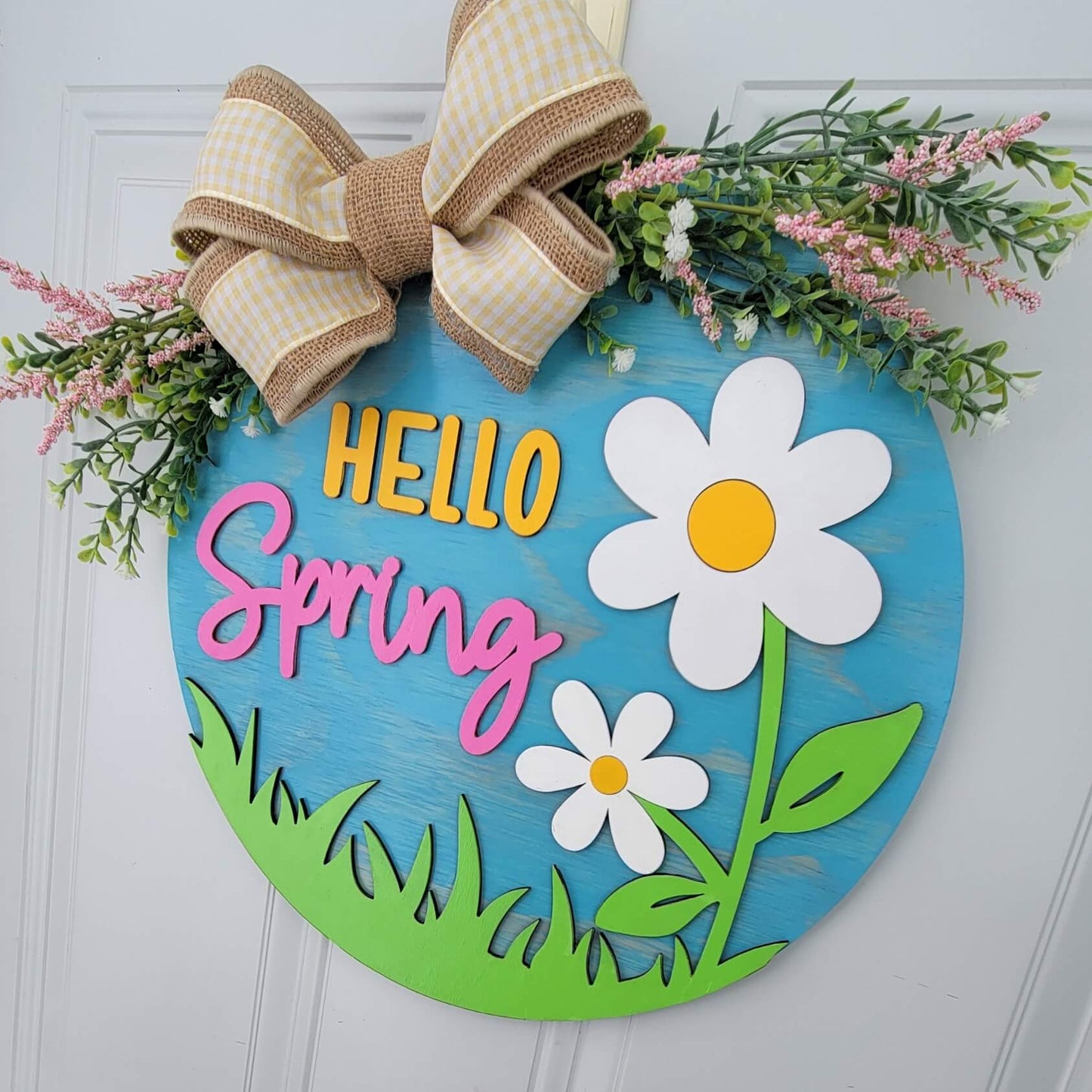 hello spring door hanger with white and yellow flowers with bow and spring greeneryangled view hanging on door