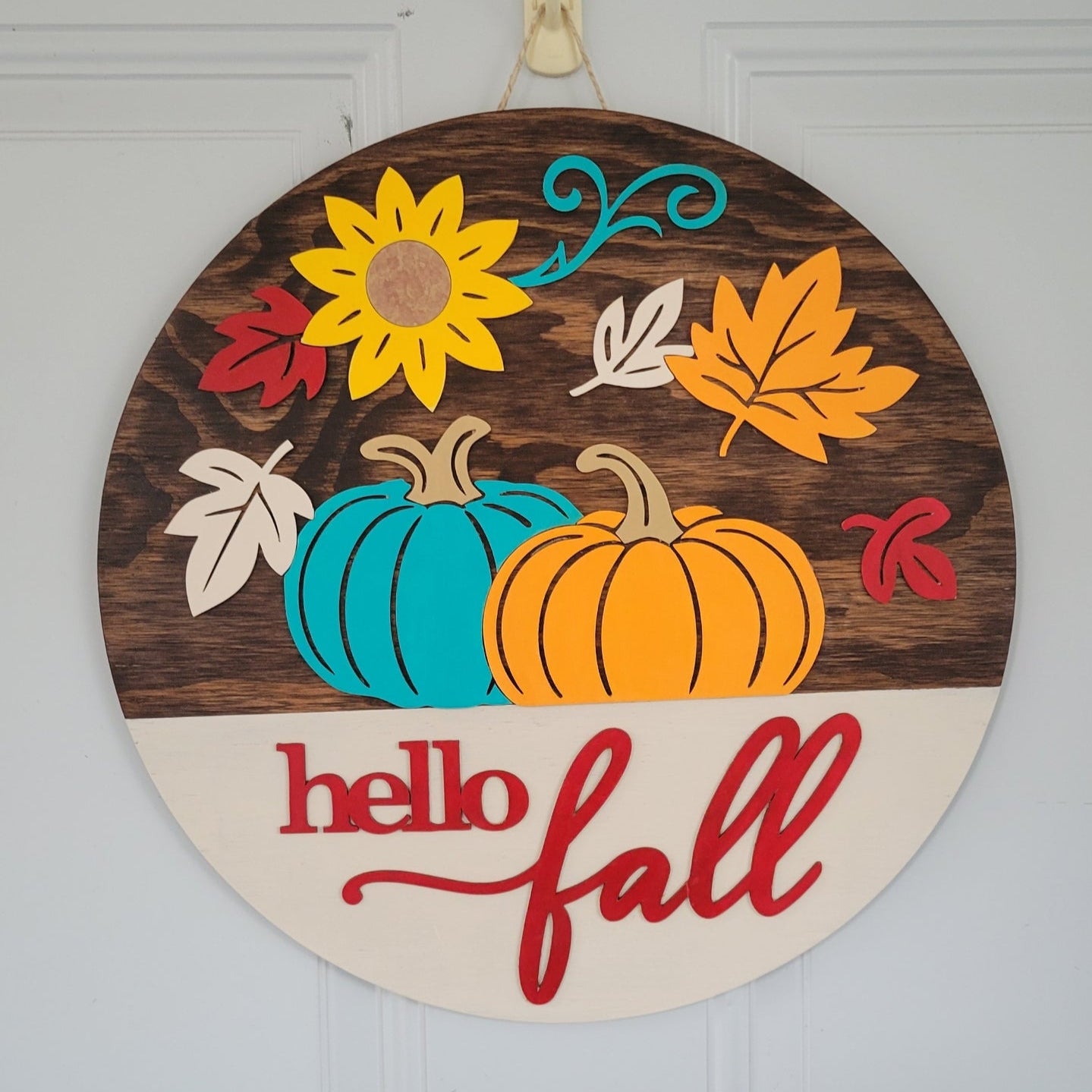 Hello Fall Door Hanger Kona Stain and Colorful Autumn Pumpkins and Leaves hanging on a door