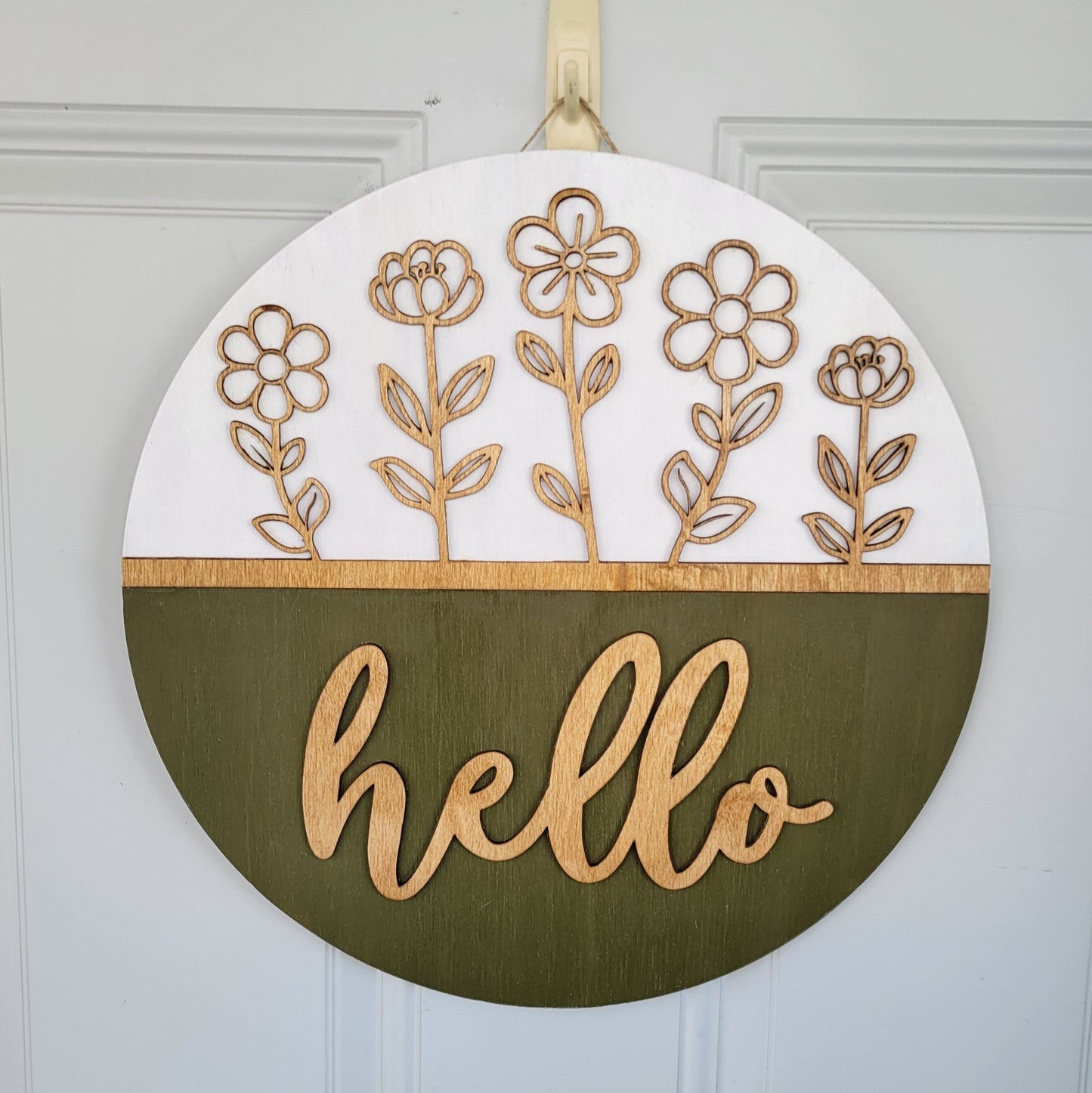 olive green, white and golden oak hello door hanger with cutout stemmed flowers hanging on door