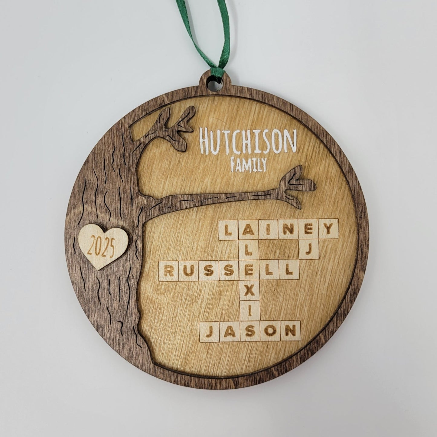 wood round ornament with last name, year and family names on white background hutchison family