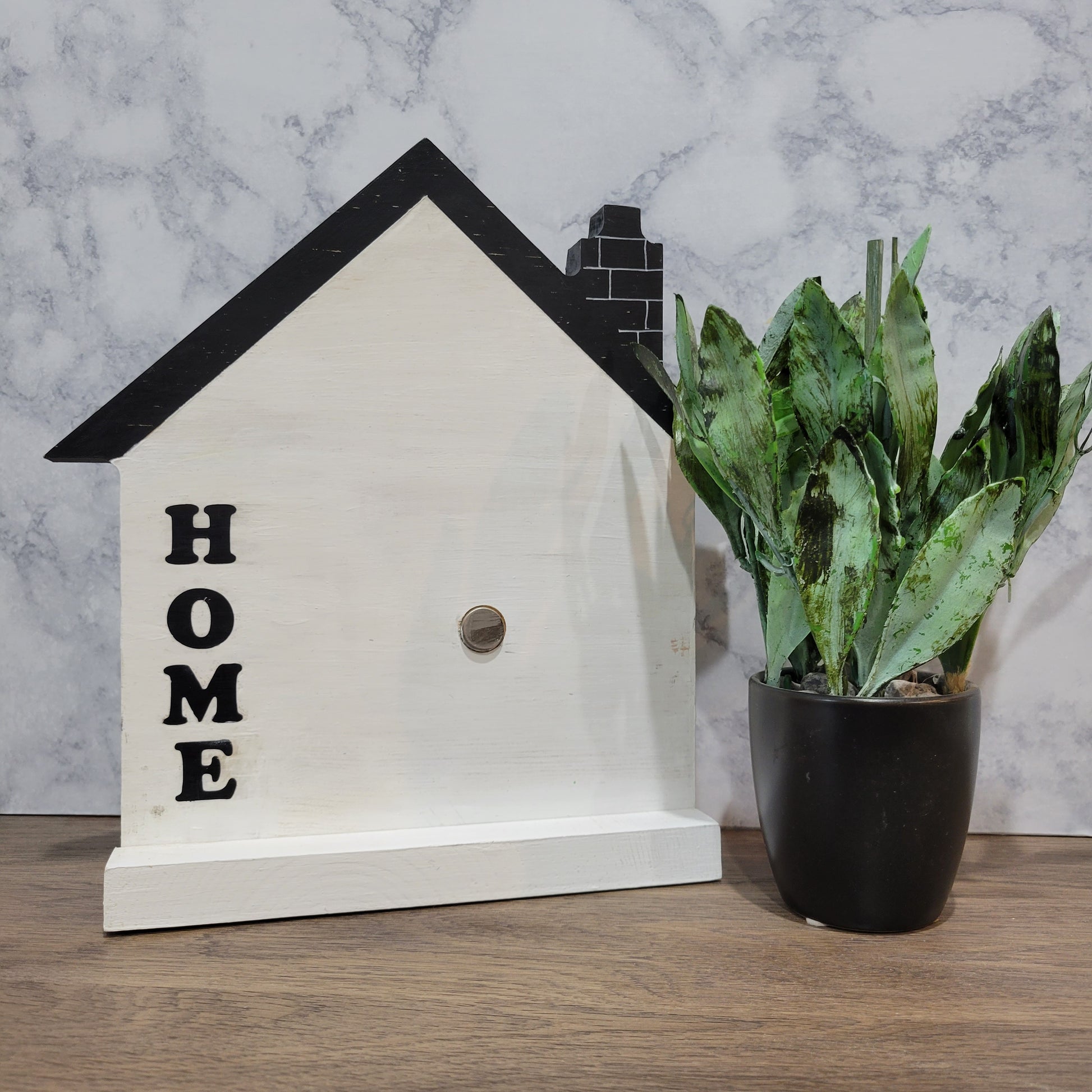 white and black house shaped wood interchangeable sign with the word home