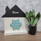 white and black house shaped wood interchangeable sign with the word home and blue and silver snowflake