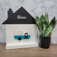 white and black house shaped wood interchangeable sign with the word home and camper