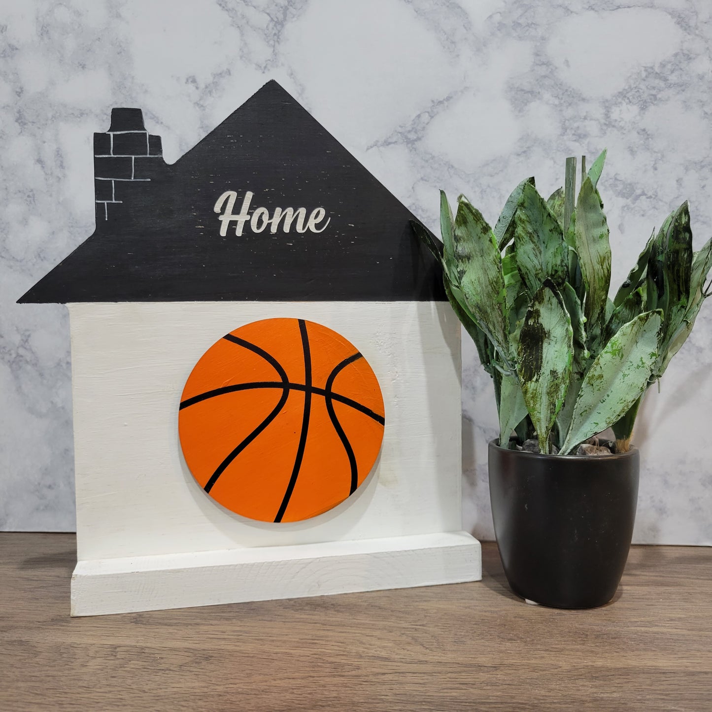 white and black house shaped wood interchangeable sign with the word home and basketball