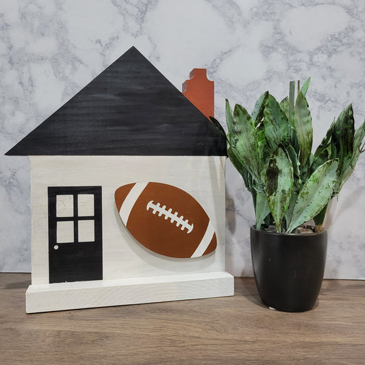 white house shaped sign with front door and football