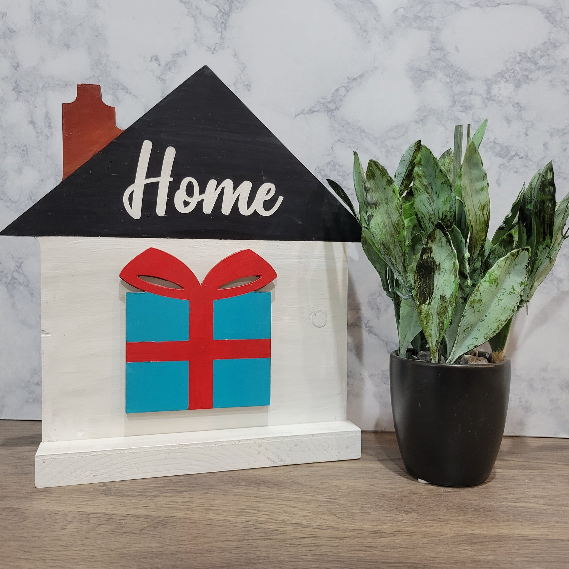 white house shaped sign with word home and christmas gift