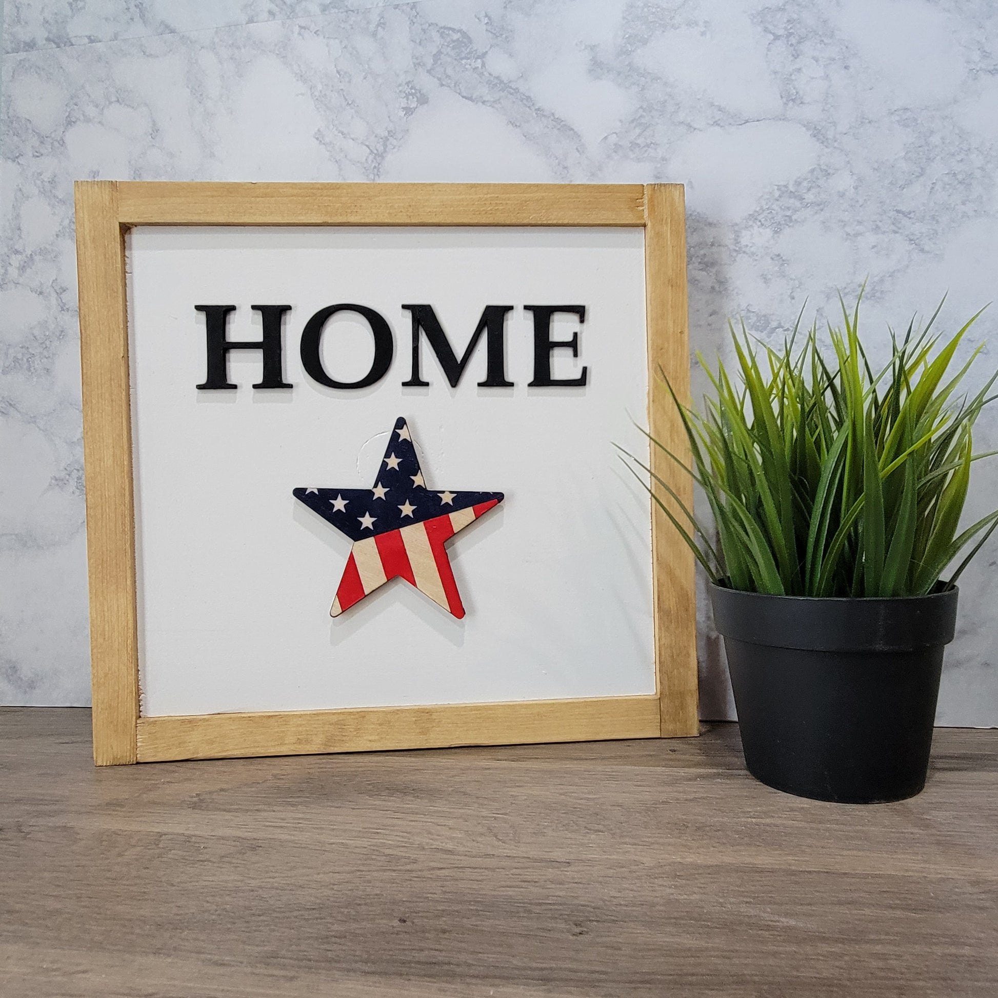 Light wood framed tabletop home sign with purple and pink spring flower with patriotic flag star