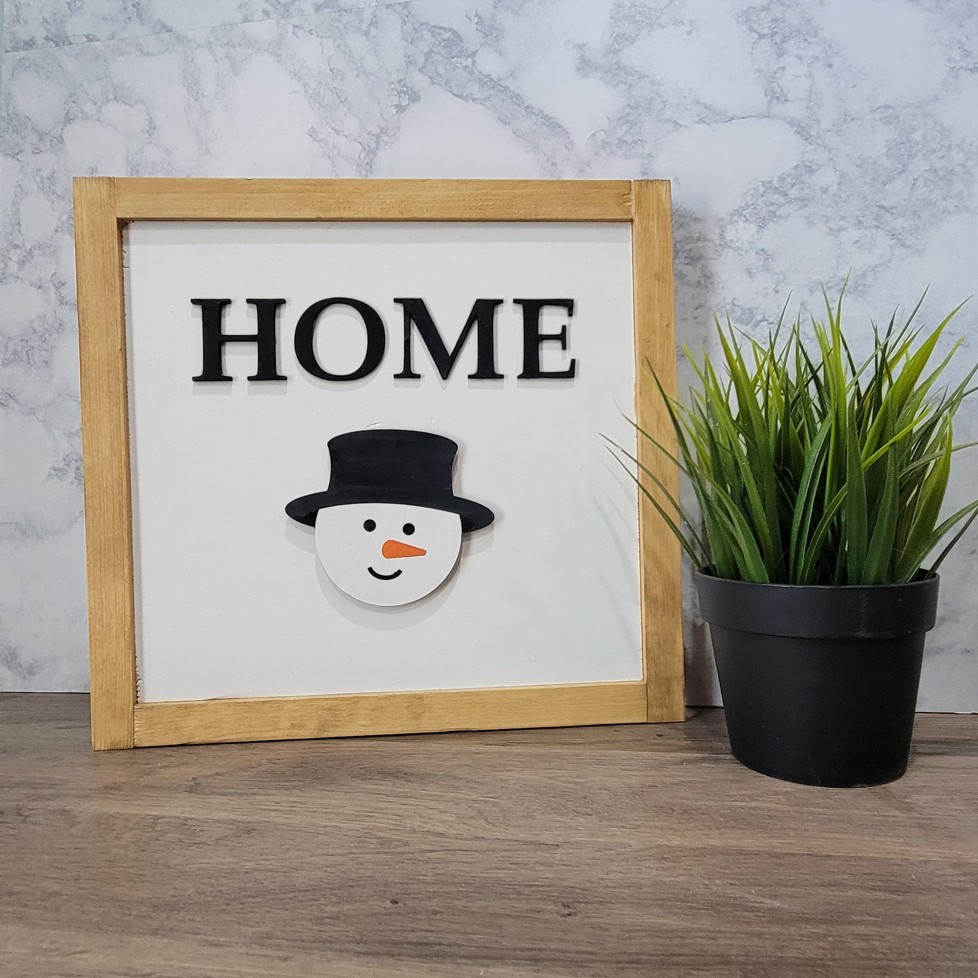 Light wood framed tabletop home sign with snowman