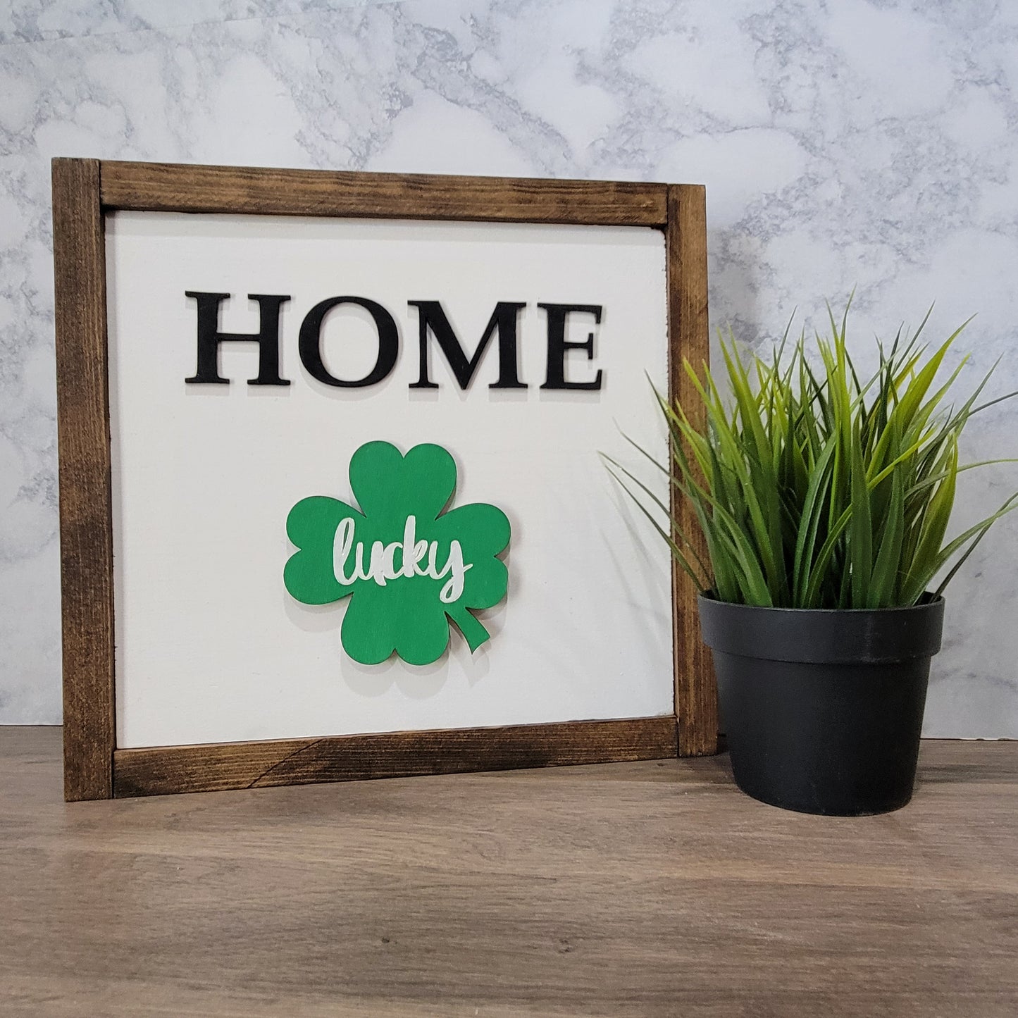 Dark wood framed home sign with lucky four leaf clover