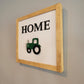 Light wood framed hanging home sign with green tractor angle