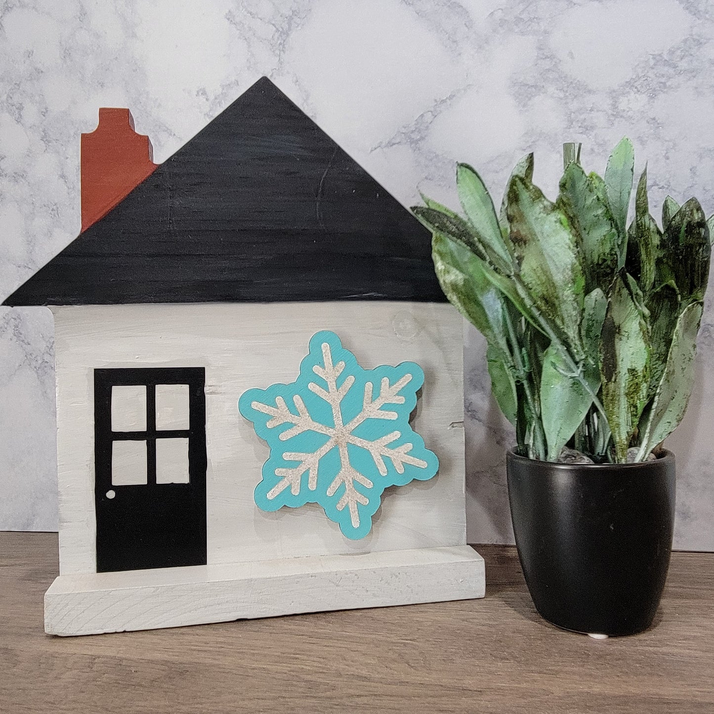 grey house shaped sign with front door and blue and silver snowflake