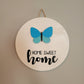 home sweet home white wood round hanging sign with butterfly