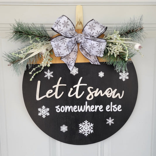 black and white Let it snow somewhere else door hanger with snowflake ribbon and pine tree greenery