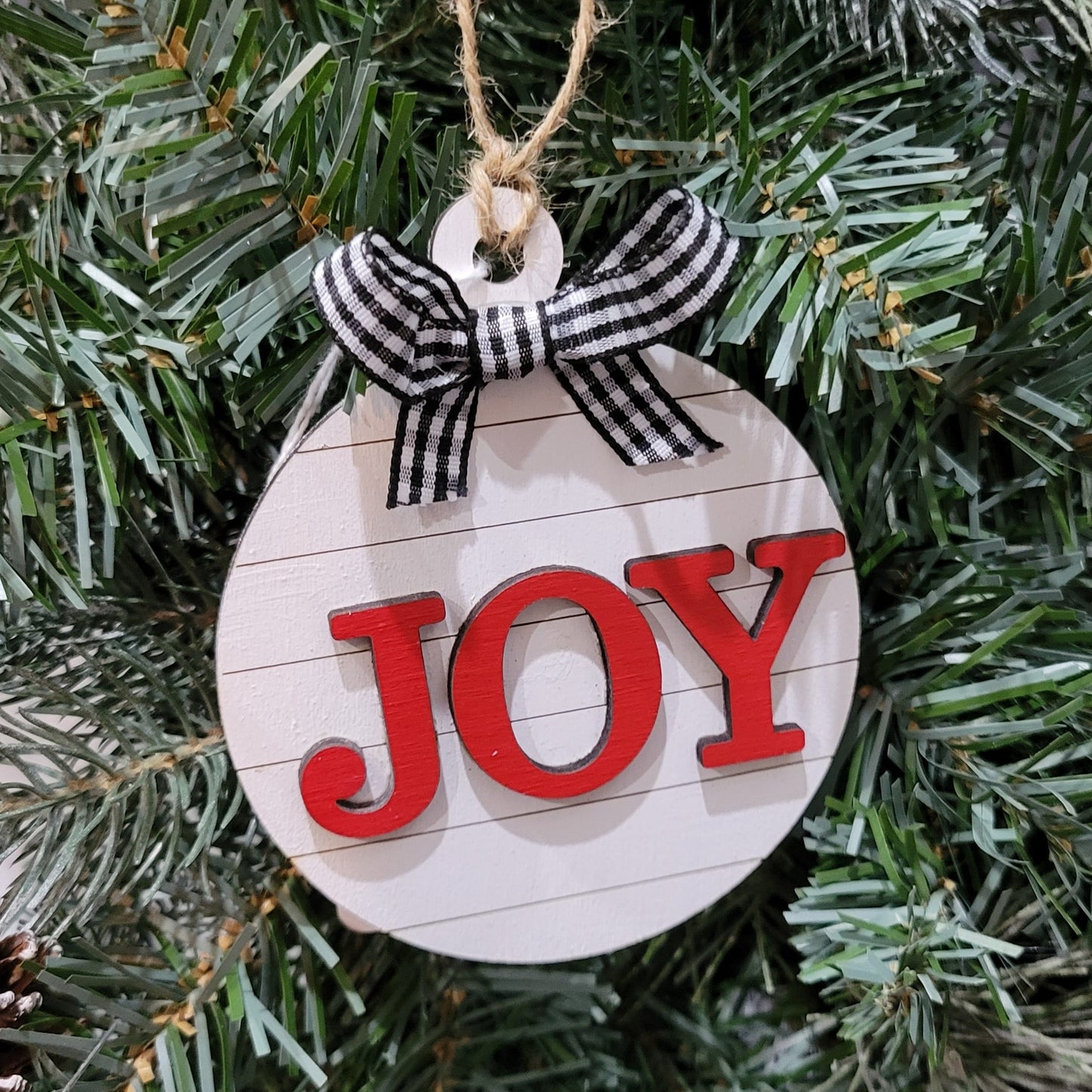 round white shiplap look striped christmas ornament with the word joy