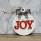 round white shiplap look striped christmas ornament with the word joy