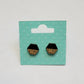 black and golden oak herringbone patterned hexagon-shaped wood engraved stud earrings on a white background
