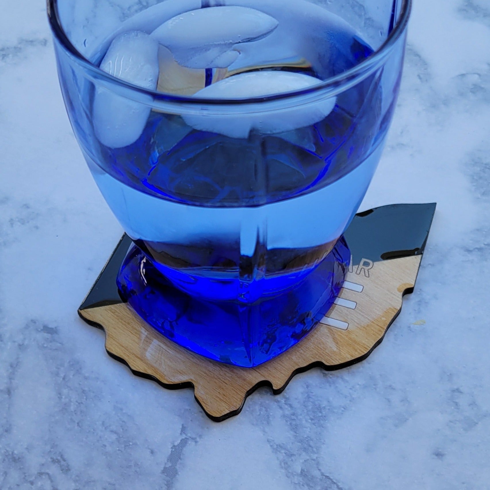 Ohio shaped total solar eclipse coaster with a drink on it