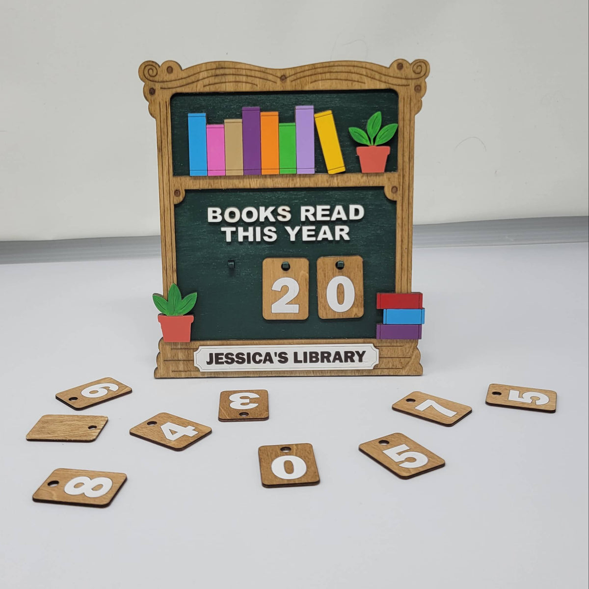 book shelf sign that says books read this year with interchangeable numbers