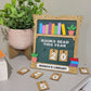 book shelf sign that says books read this year with interchangeable numbers sitting on a table next to a book and plant