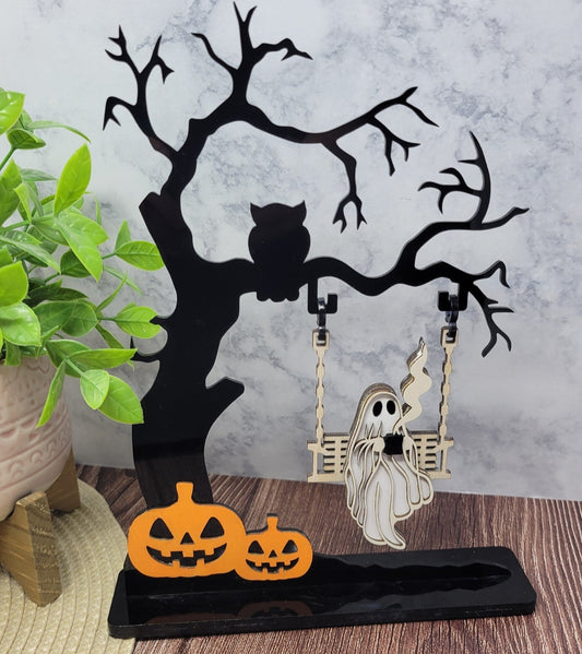 Ghost on a creepy Halloween tree swinging and drinking coffee