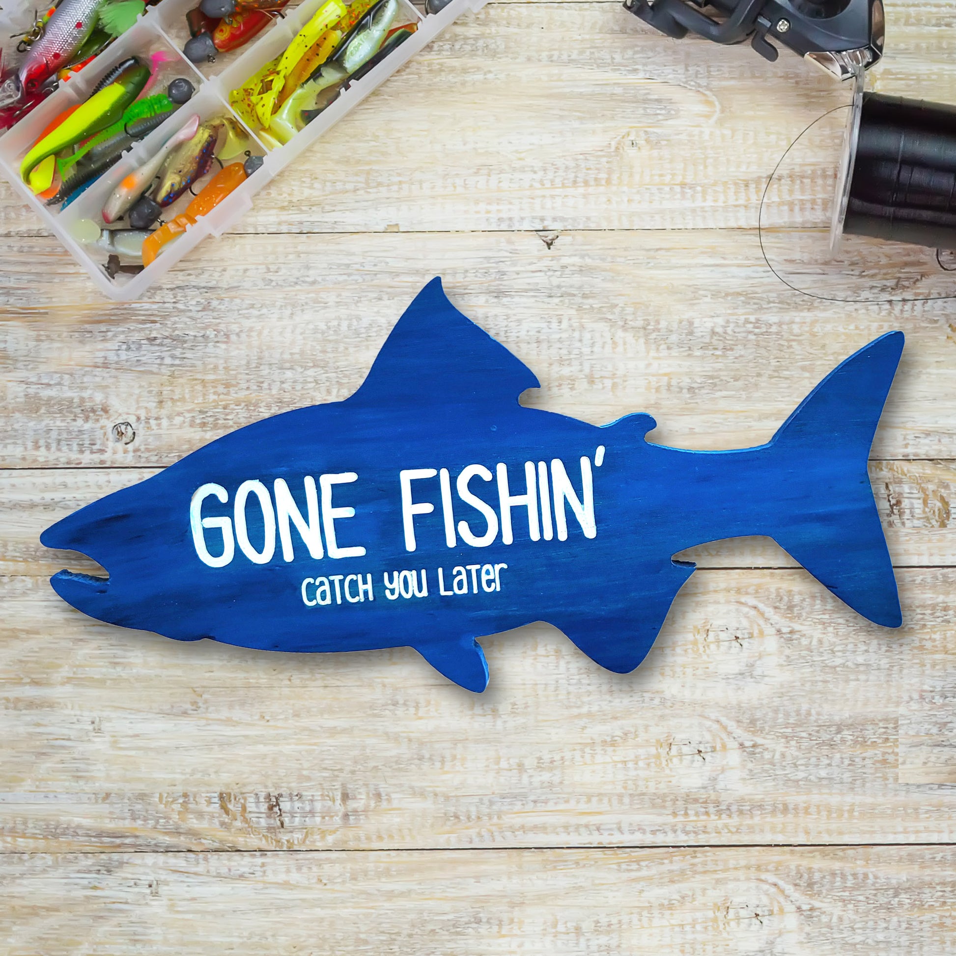 blue fish-shaped wood gone fishin catch you later sign