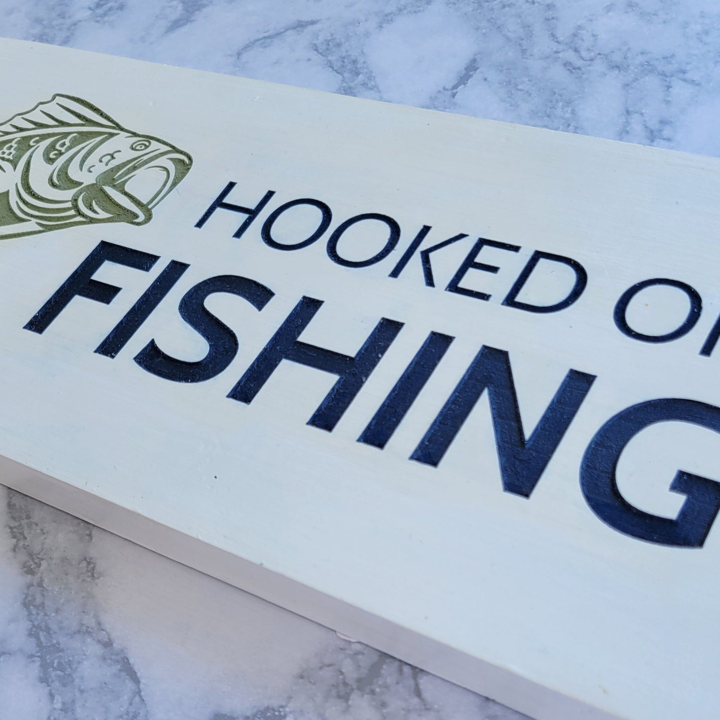 hooked on fishing white blue and green sign with a fish