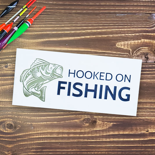 hooked on fishing white blue and green sign with a fish