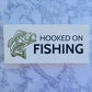 hooked on fishing white blue and green sign with a fish