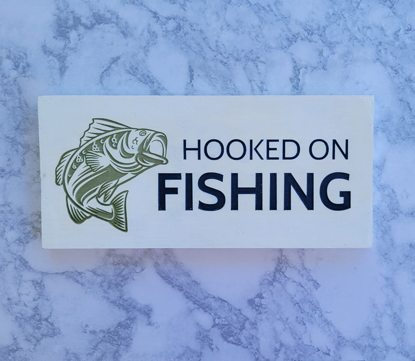 hooked on fishing white blue and green sign with a fish