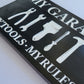 black and white wood handmade my garage my tools my rules sign close up