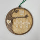 wood round ornament with last name, year and family names on white background sink family
