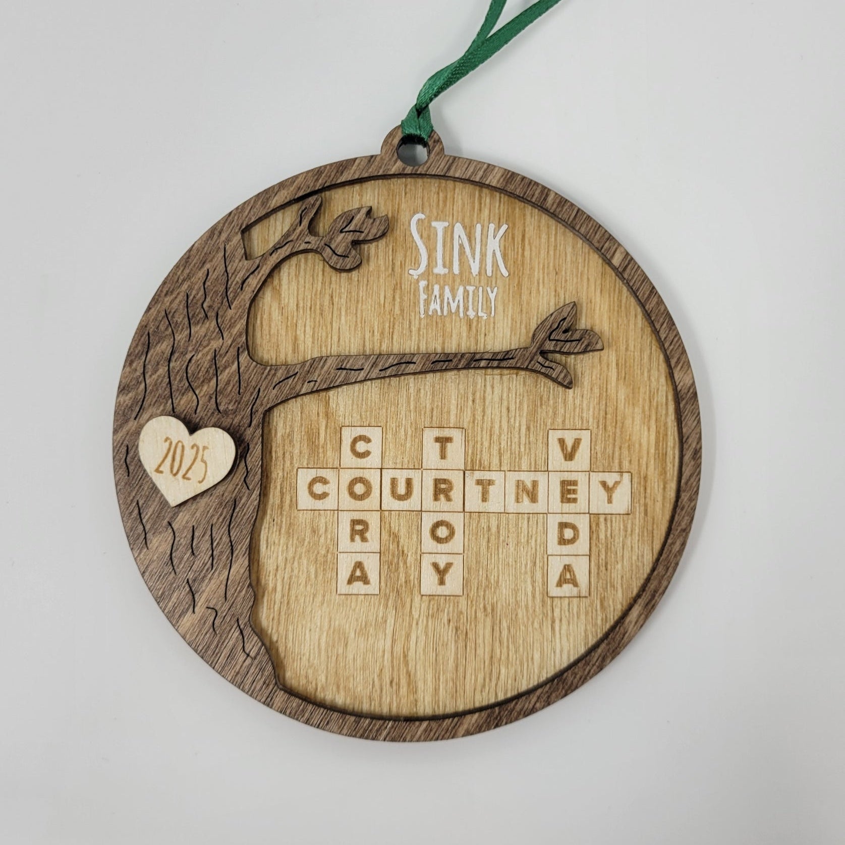 wood round ornament with last name, year and family names on white background sink family